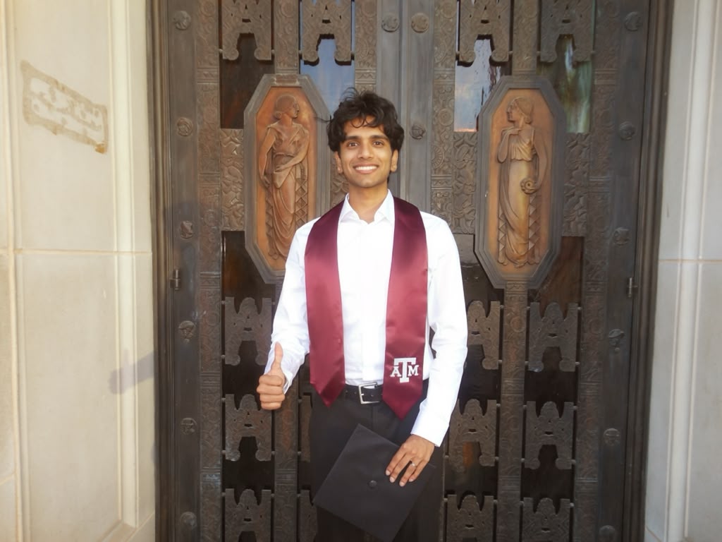 Graduation photo in front of Texas A&M campus doors