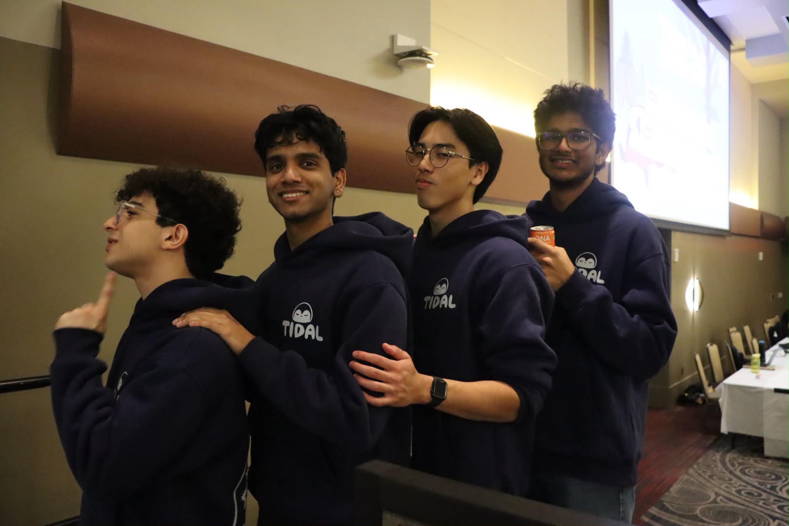 Team photo wearing TIDAL hoodies at a hackathon